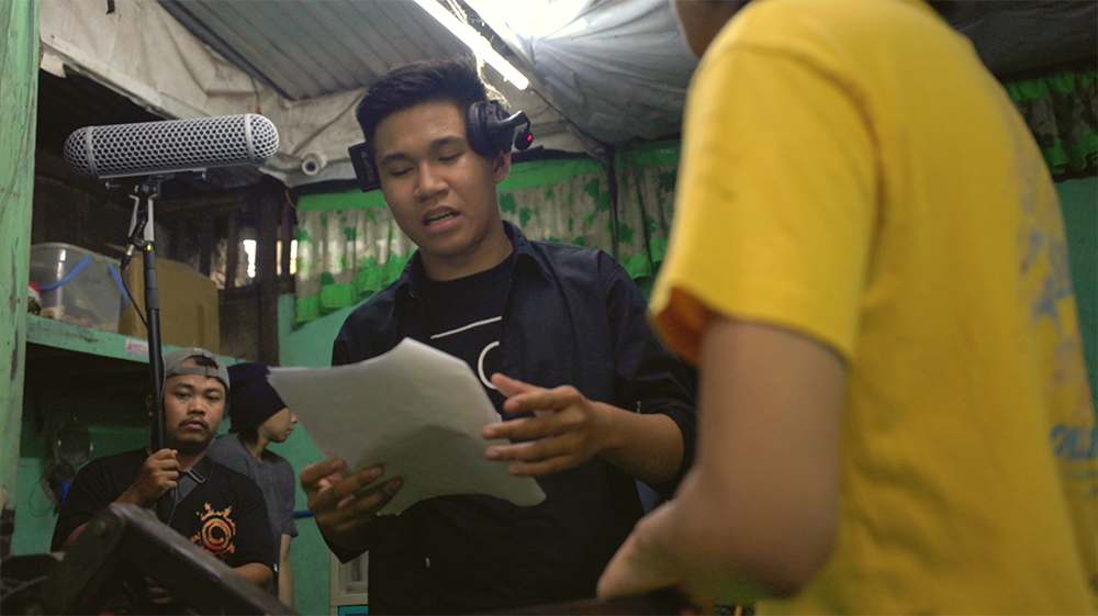 Silkscreen director Rey Anthony Villaverde talks to his crew